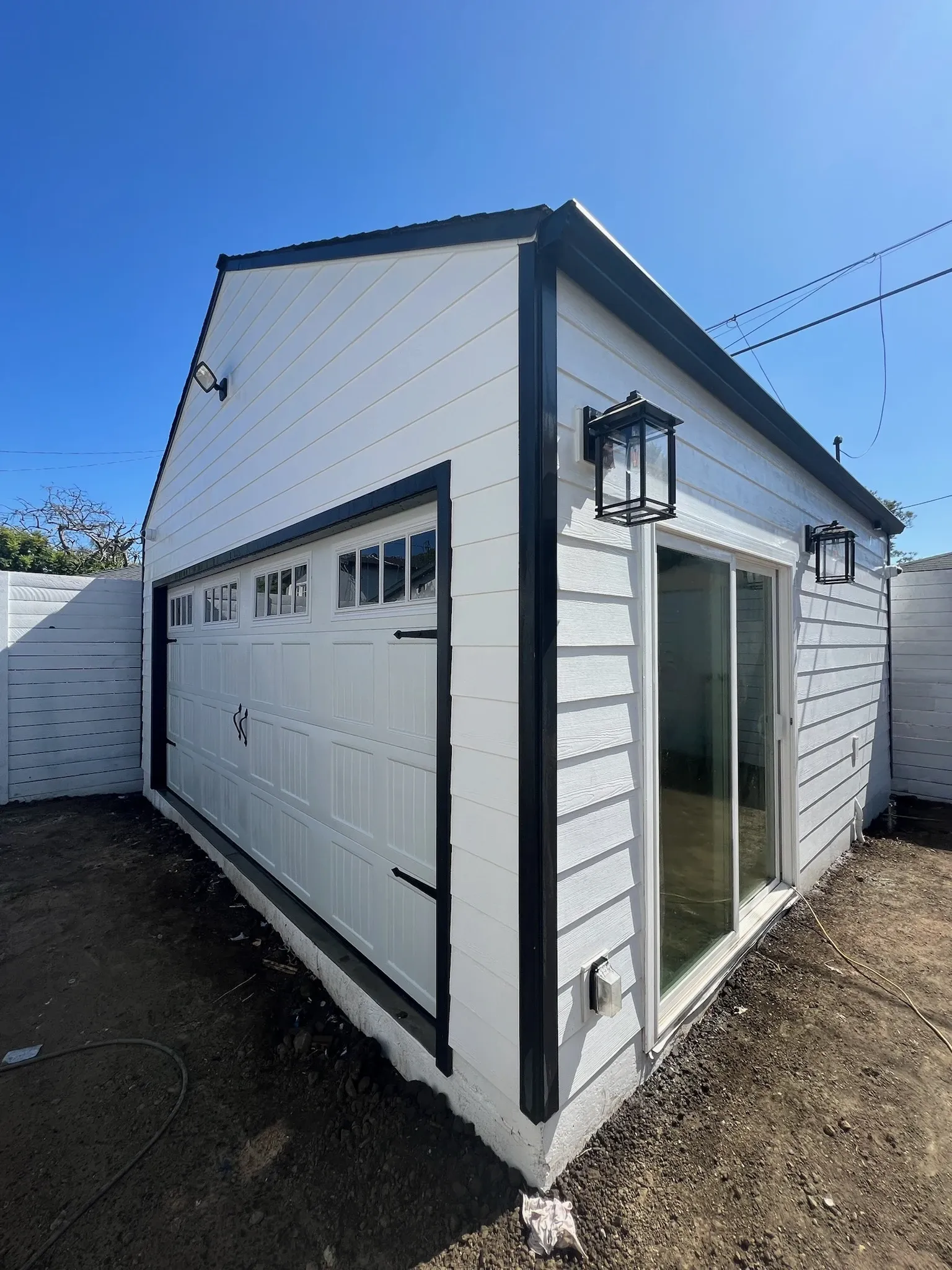 Detached ADU exterior with garage door and glass slider