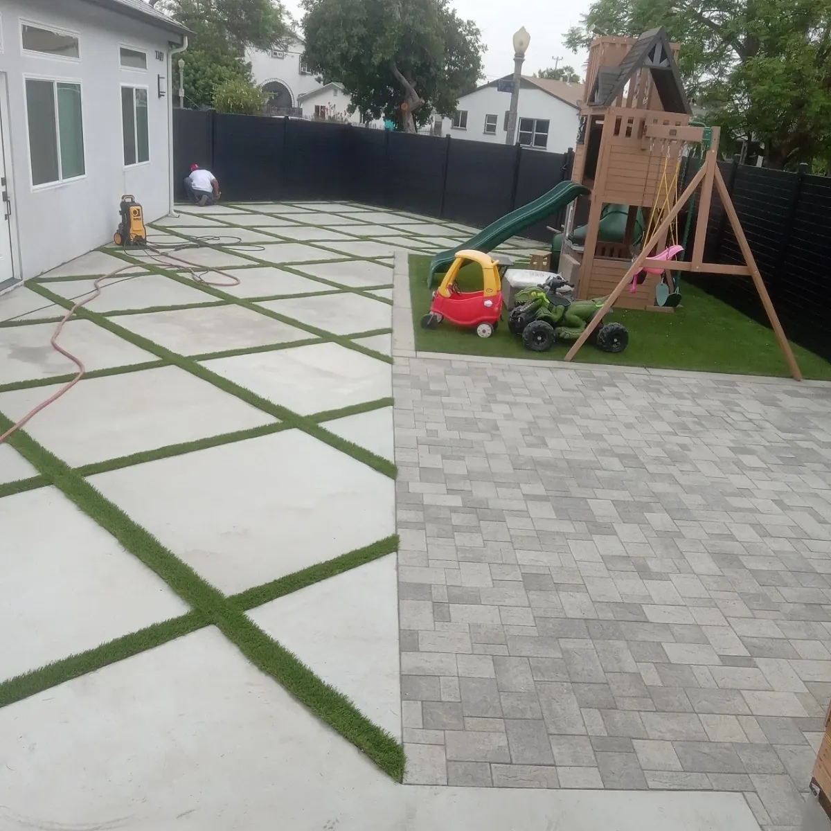 Concrete paver grid with grass joints in a modern backyard