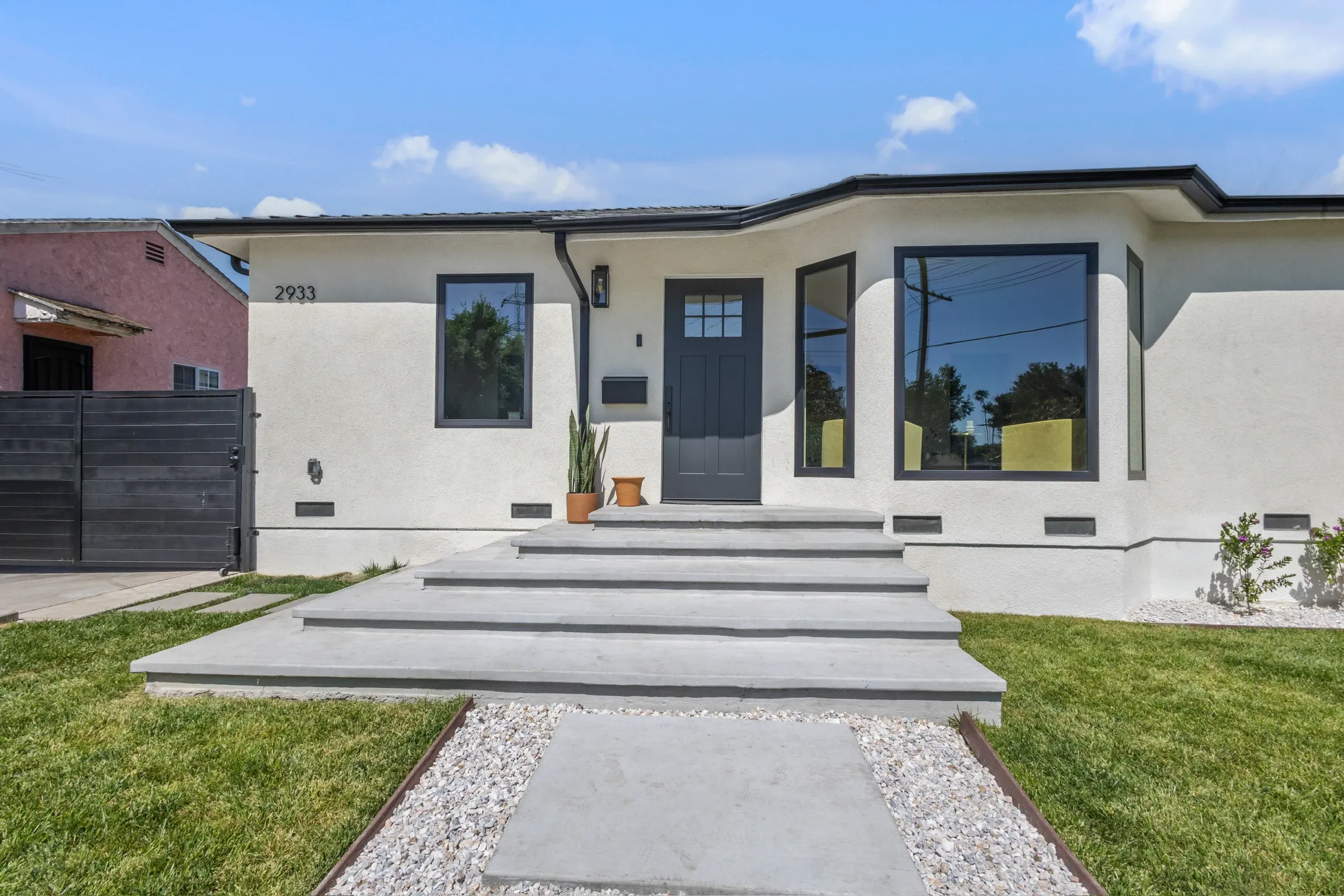 Floating concrete steps and front walkway with gravel border