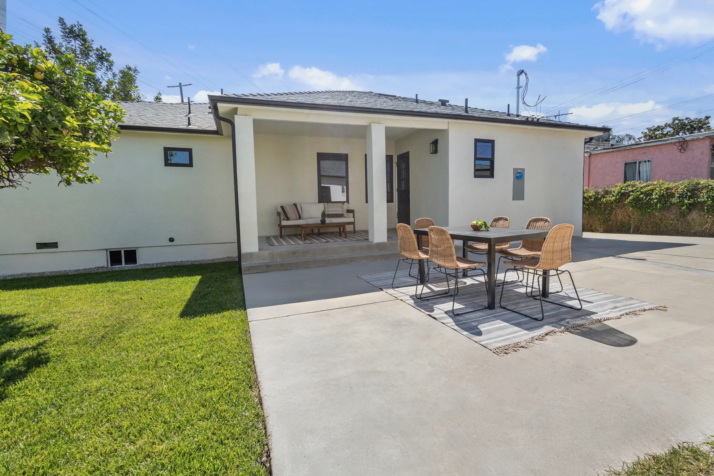 Rear yard concrete patio with covered seating area